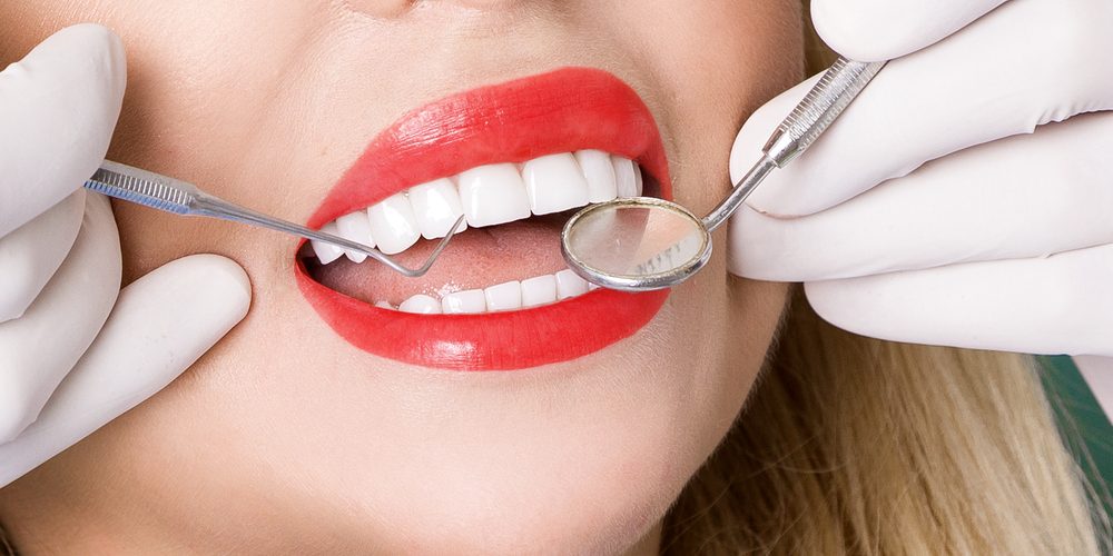 Woman with white straight teeth having checkup