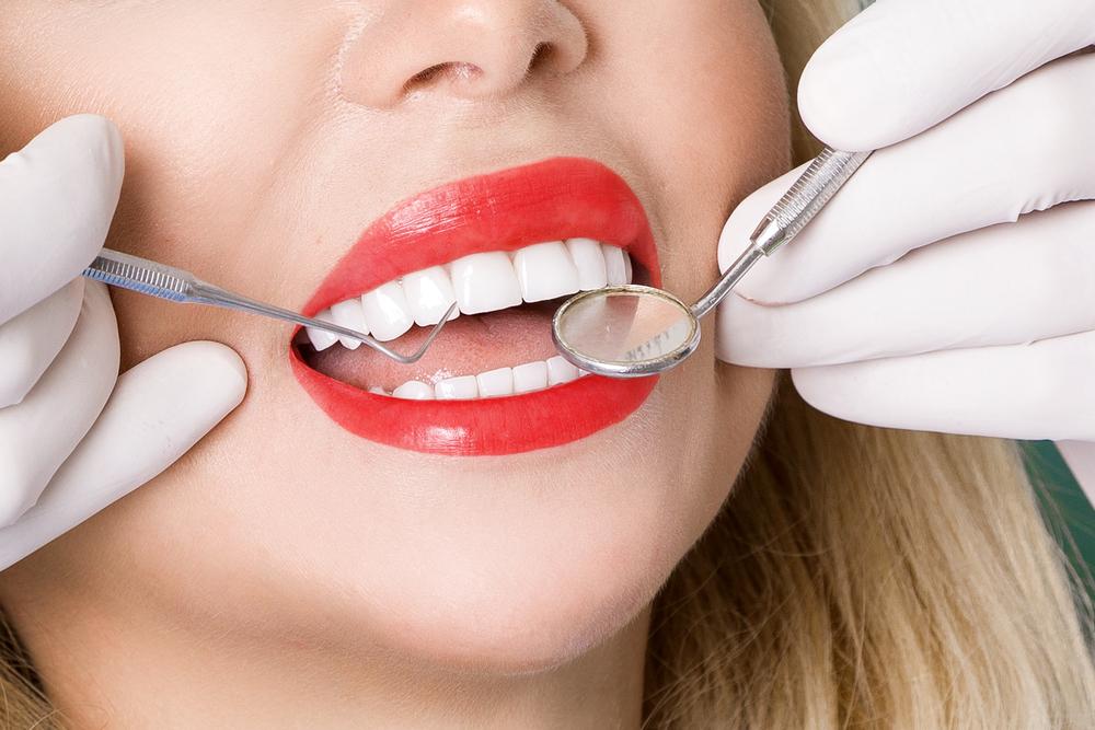 Woman with white straight teeth having checkup