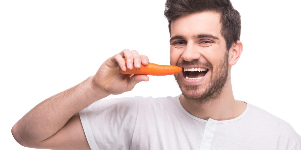 Man eating a carrot