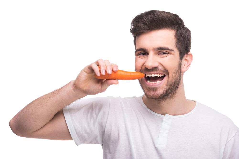 Man eating a carrot