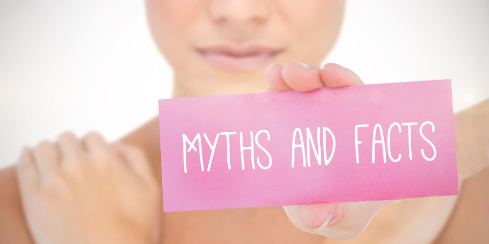 The Word Myths And Facts And Young Woman Holding