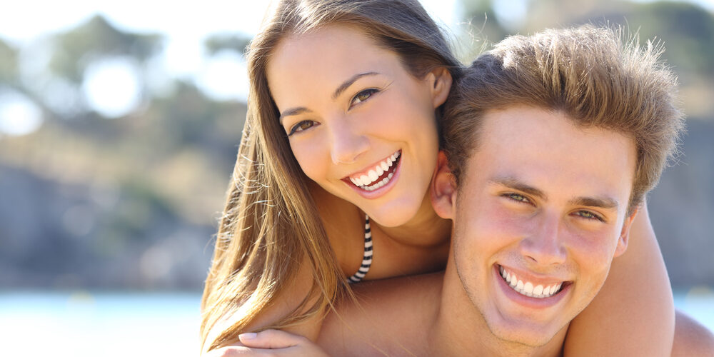 Happy,Couple,With,Perfect,Smile,And,White,Teeth,Posing,On Happy Couple With Perfect Smile And White Teeth Posing On