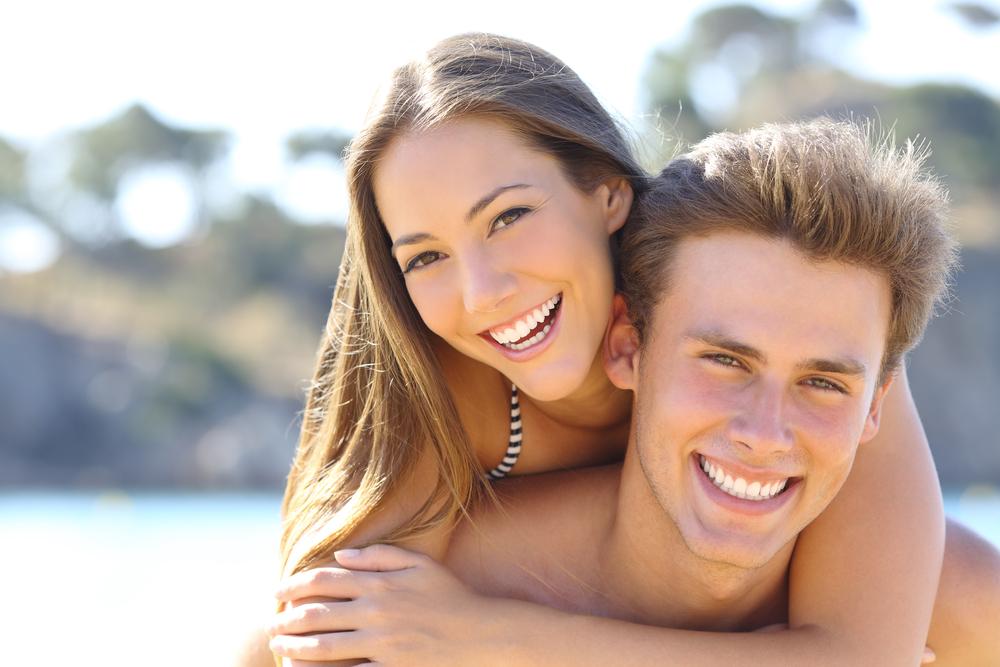 Happy Couple With Perfect Smile And White Teeth Posing On