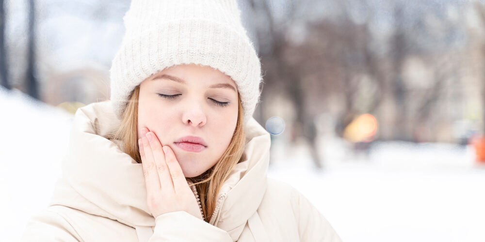 Teen Girl Has A Toothache Outdoor In Winter. Tooth Enamel