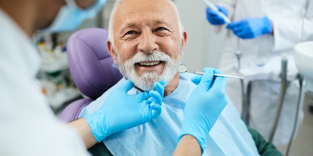 Happy,Mature,Man,During,Teeth,Check-up,At,Dental,Clinic.